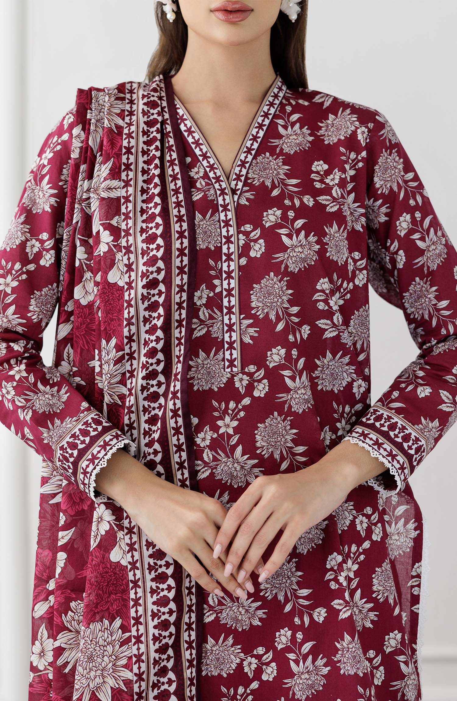 UNSTITCHED Printed Lawn Shirt Dupatta & Pant - 3 Piece Suits - OTL-25-060. Woman wearing a maroon floral dress with white patterns with printed dupatta on a plain trouser.