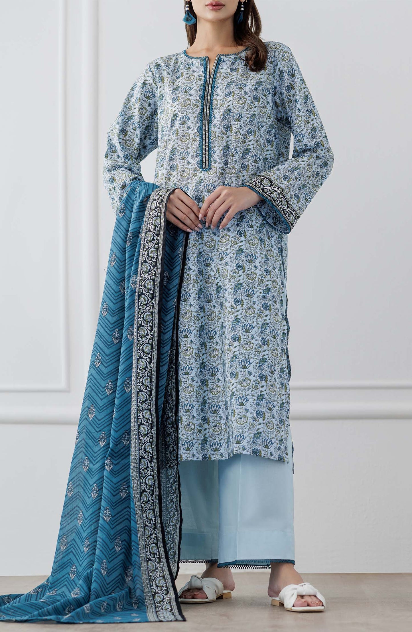 UNSTITCHED Printed Lawn Shirt Dupatta & Pant - 3 Piece Suits - OTL-25-347. Woman wearing a blue and white patterned kurta with a matching dupatta  and dyed trouser.
