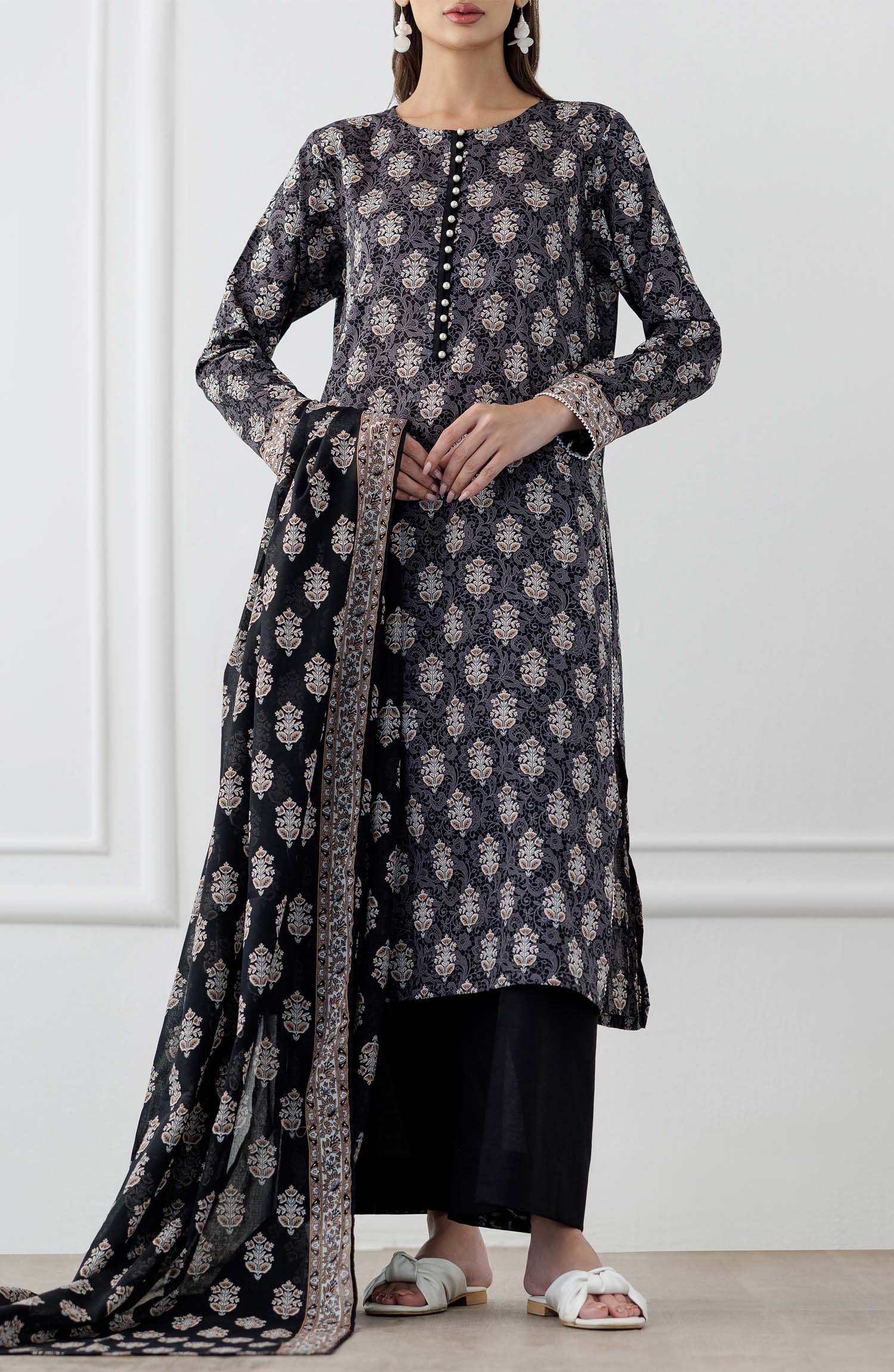 UNSTITCHED Printed Lawn Shirt Dupatta & Pant - 3 Piece Suits - OTL-25-105. Woman wearing a black and white patterned kurta with a matching dupatta in a minimalistic setting and plain trouser.